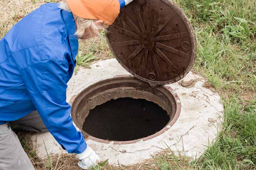 plumber inspecting septic tank