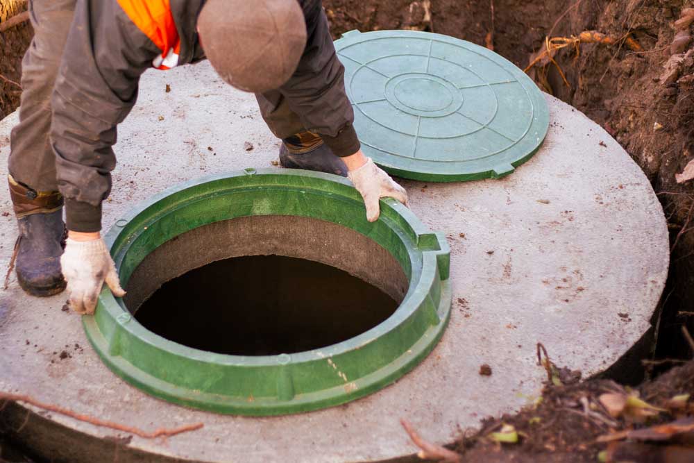 Las Vegas Septic Service technician standing beside a septic system