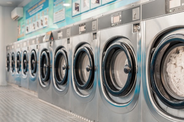 row of washing machine in laundromat